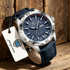 A silver and blue luxury men's quartz watch with a dark blue strap is displayed on a wooden surface.