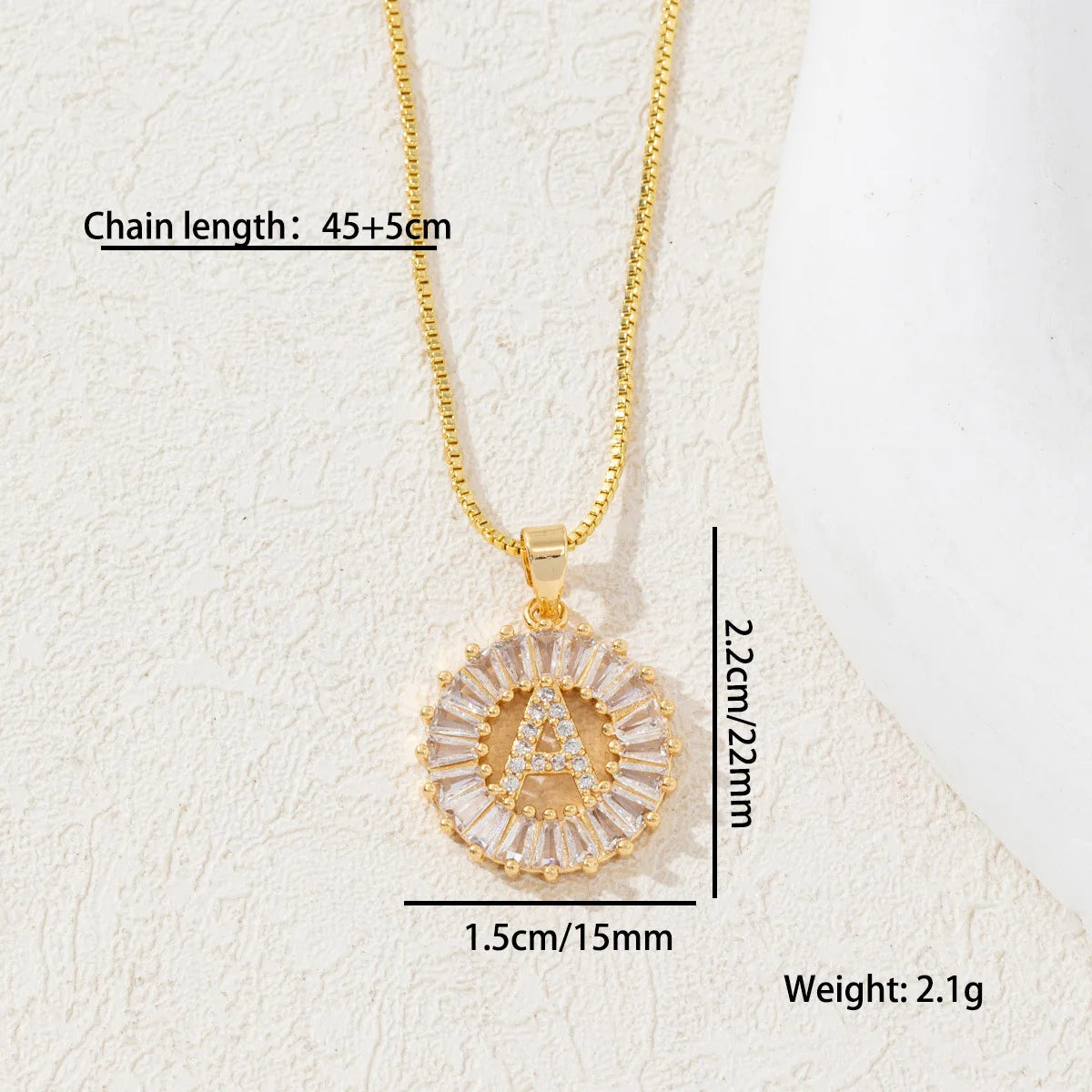 Gold chain necklace with a crystal pendant shaped like the letter A