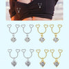 A collection of heart dangle non-piercing nipple rings in silver and gold with cubic zirconia stones.